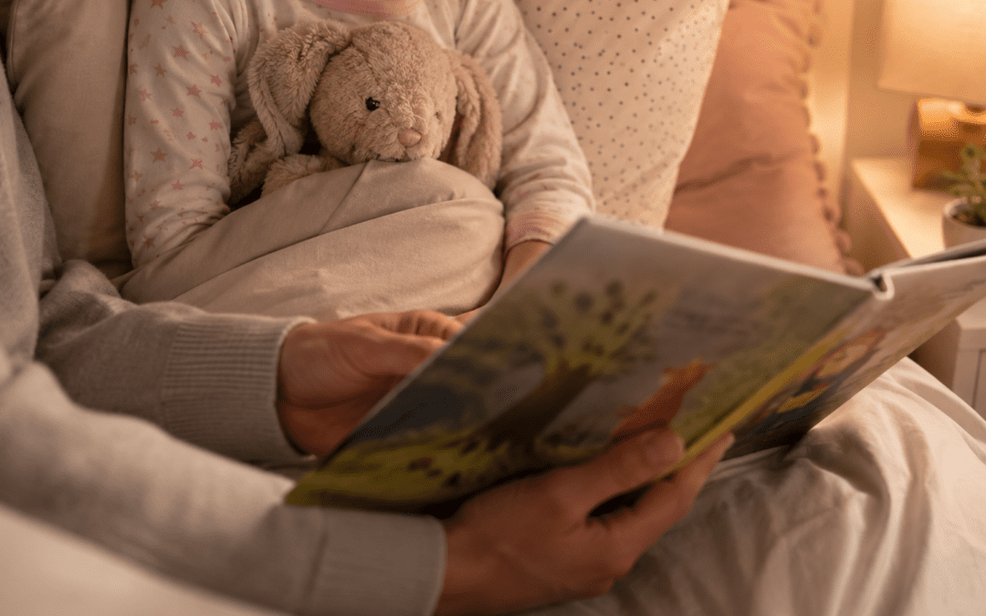 Parent reading to child in bed with soft lighting